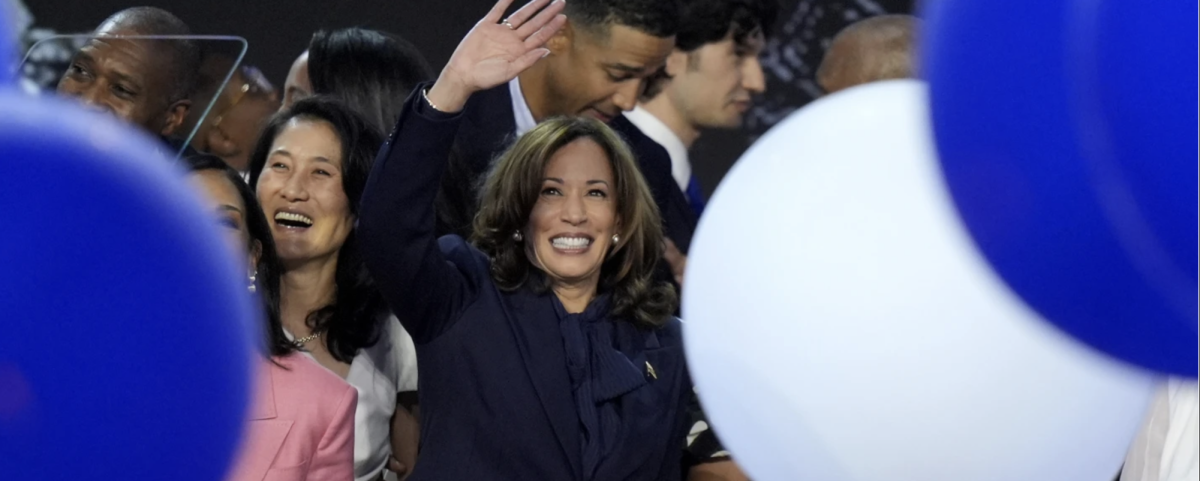 Kamala Harris waves at the delegates at the Democratic National Convention.